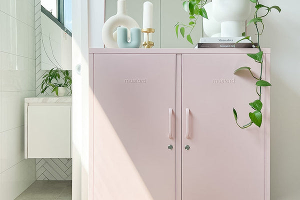 Mustard Made locker in Blush styled in a bathroom with an arch mirror and trailing plant
