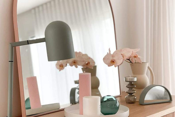 Styled wooden console table with round mirror, modern lamp, vases, and decorative objects for console like a PRO design