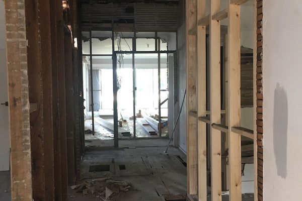 Interior view of house under renovation showing exposed wooden framing and floor structure in norsuHOME - The Transformation project