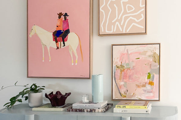 Limited edition art hung at eye level above a console in a styled norsu interior