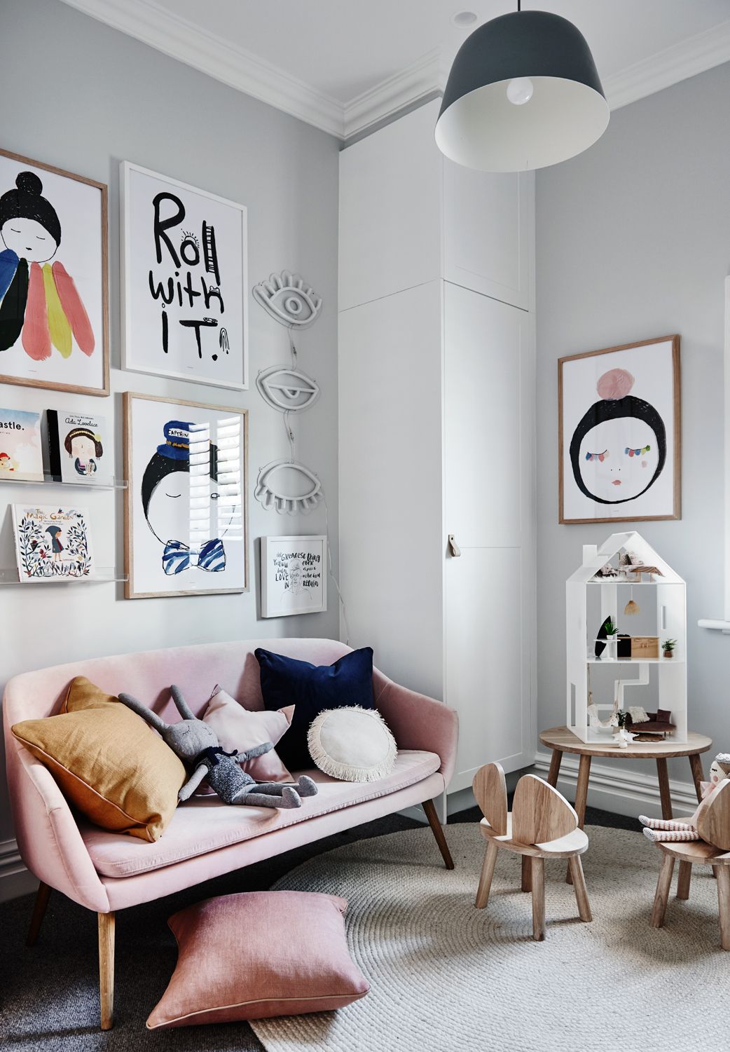 Cozy children's room with norsuHOME flooring, pink sofa, wall art, and wooden toys