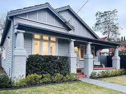 Modern grey house exterior with porch and well-maintained garden showcasing norsuHOME - Outdoors design