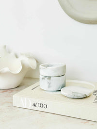 Stackable marble jewellery organiser with compact cylindrical design and removable layers for flexible storage