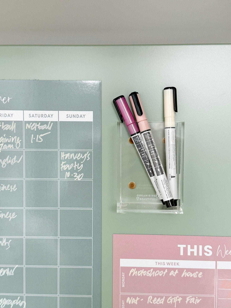 Blush A4 magnet meal planner on fridge with pink and black markers for weekly menu organization