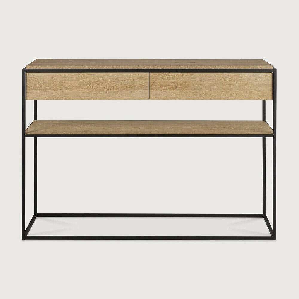 Ethnicraft Monolit Console in natural oak with black lacquered metal frame, two drawers, and lower shelf.
