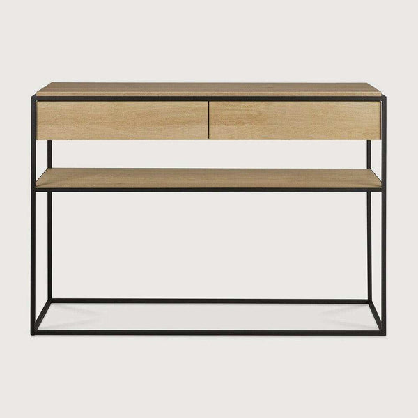 Ethnicraft Monolit Console in natural oak with black lacquered metal frame, two drawers, and lower shelf.