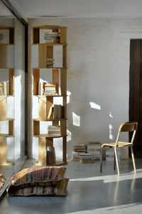 Ethnicraft Stairs Column Bookshelf - Oak, styled in a room setting