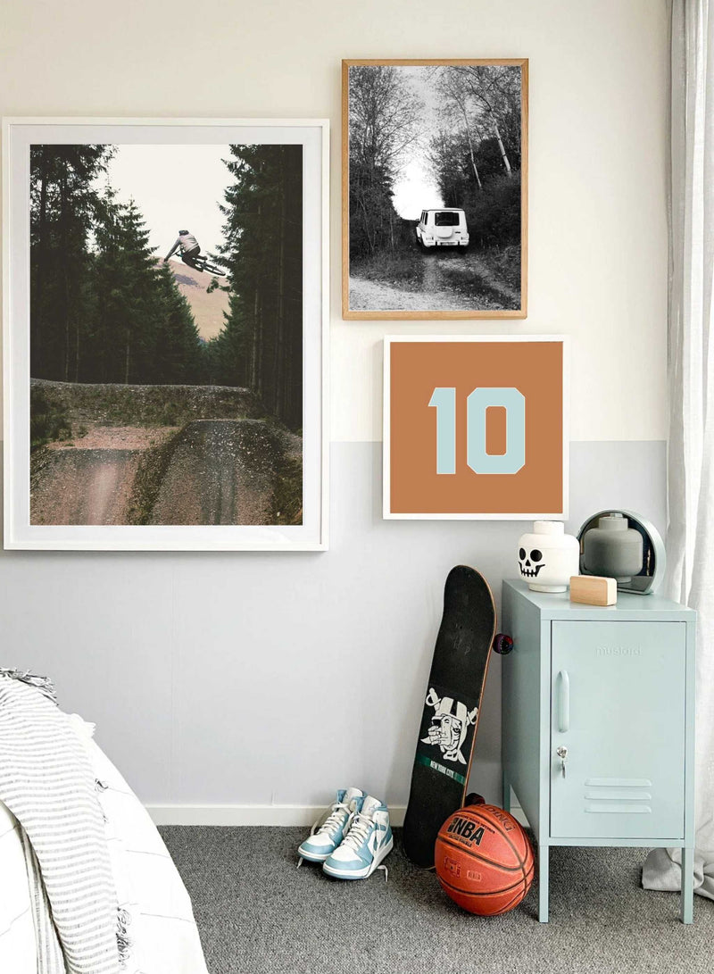 Customizable wall art print with sports-themed photographic designs and personalized number in various colors, displayed in a modern room setting.