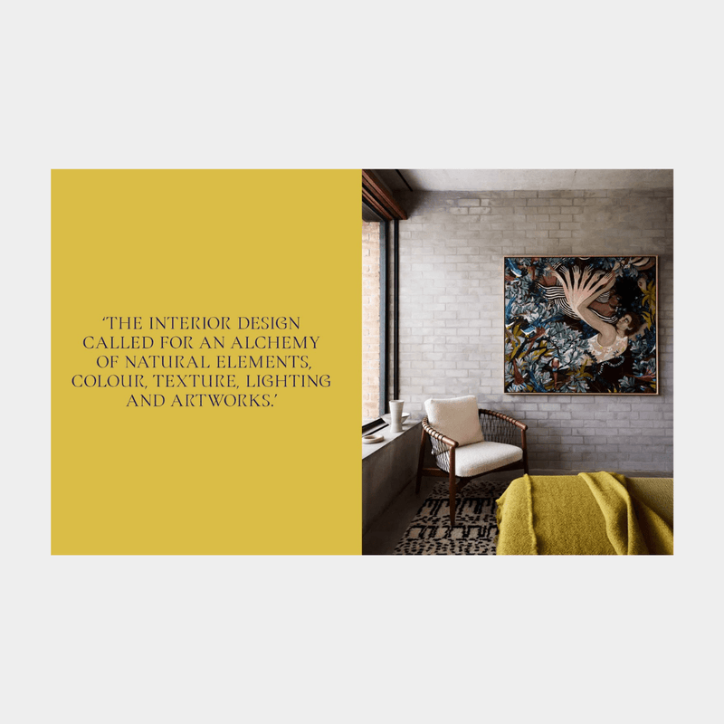 Modern interior living room with textured gray walls, wooden chair, colorful wall art, and yellow throw blanket, showcasing Arent & Pyke design philosophy