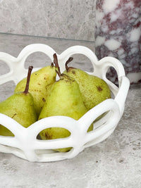 Rye Stoneware ceramic basket in white cream glaze holding fresh pears on countertop
