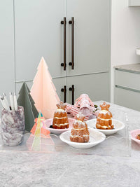norsu Studio small white bowl with pink bow on kitchen counter with desserts and decorative items