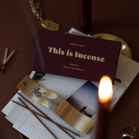 Gentle Habits Heartfire incense packaging with lit incense stick on a dark surface