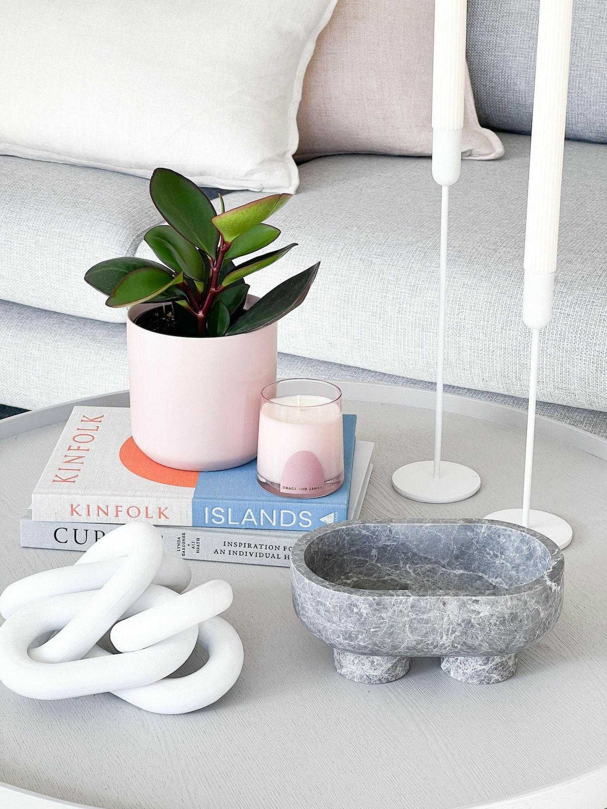 CoTheory Marble Footed Oval Tray in Tundra Grey Marble on modern coffee table with decorative items