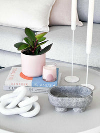 CoTheory Marble Footed Oval Tray in Tundra Grey Marble on modern coffee table with decorative items