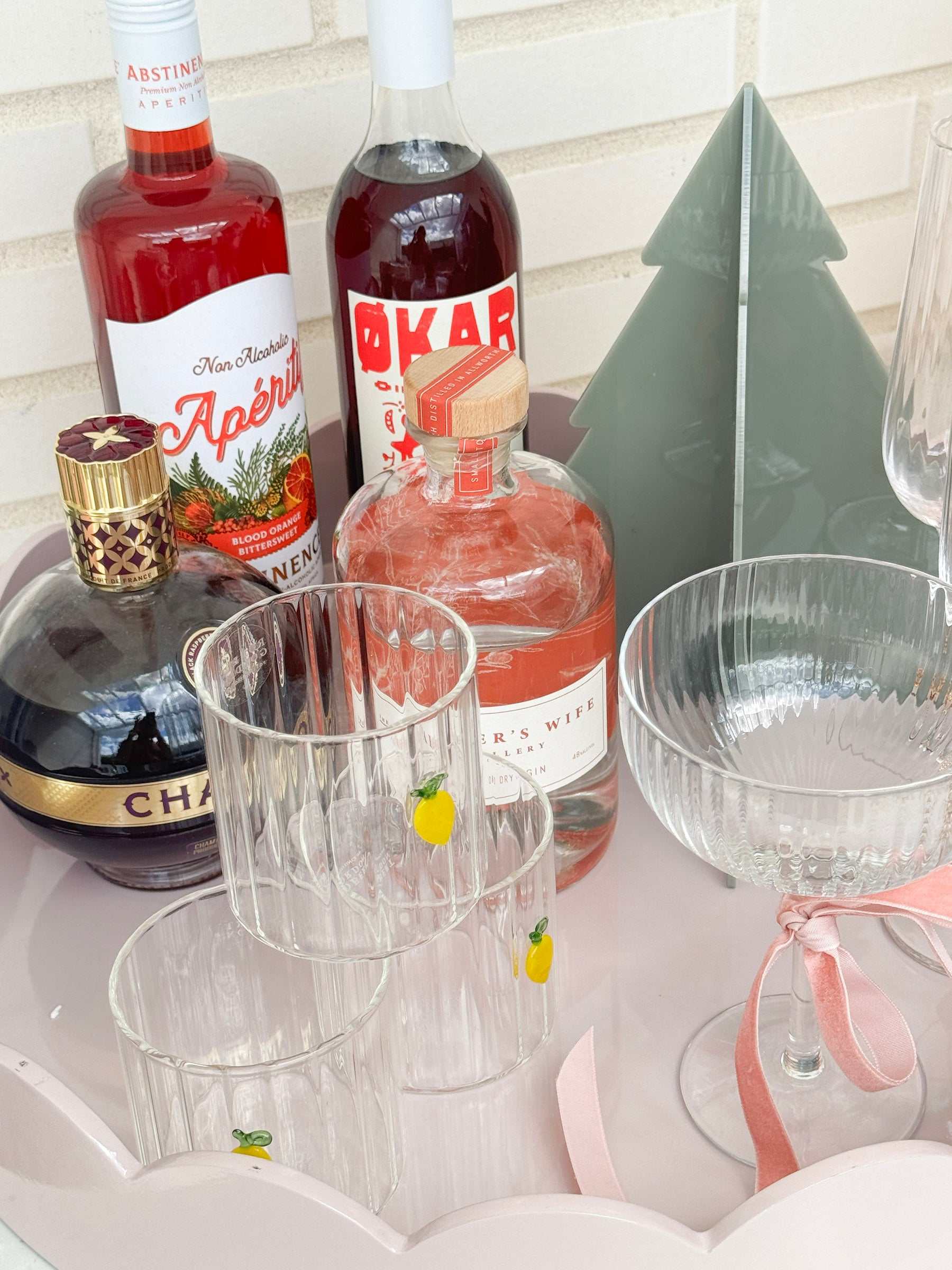 norsu Studio Perspex sage standing Christmas trees set of 3 on table with drinks and glassware