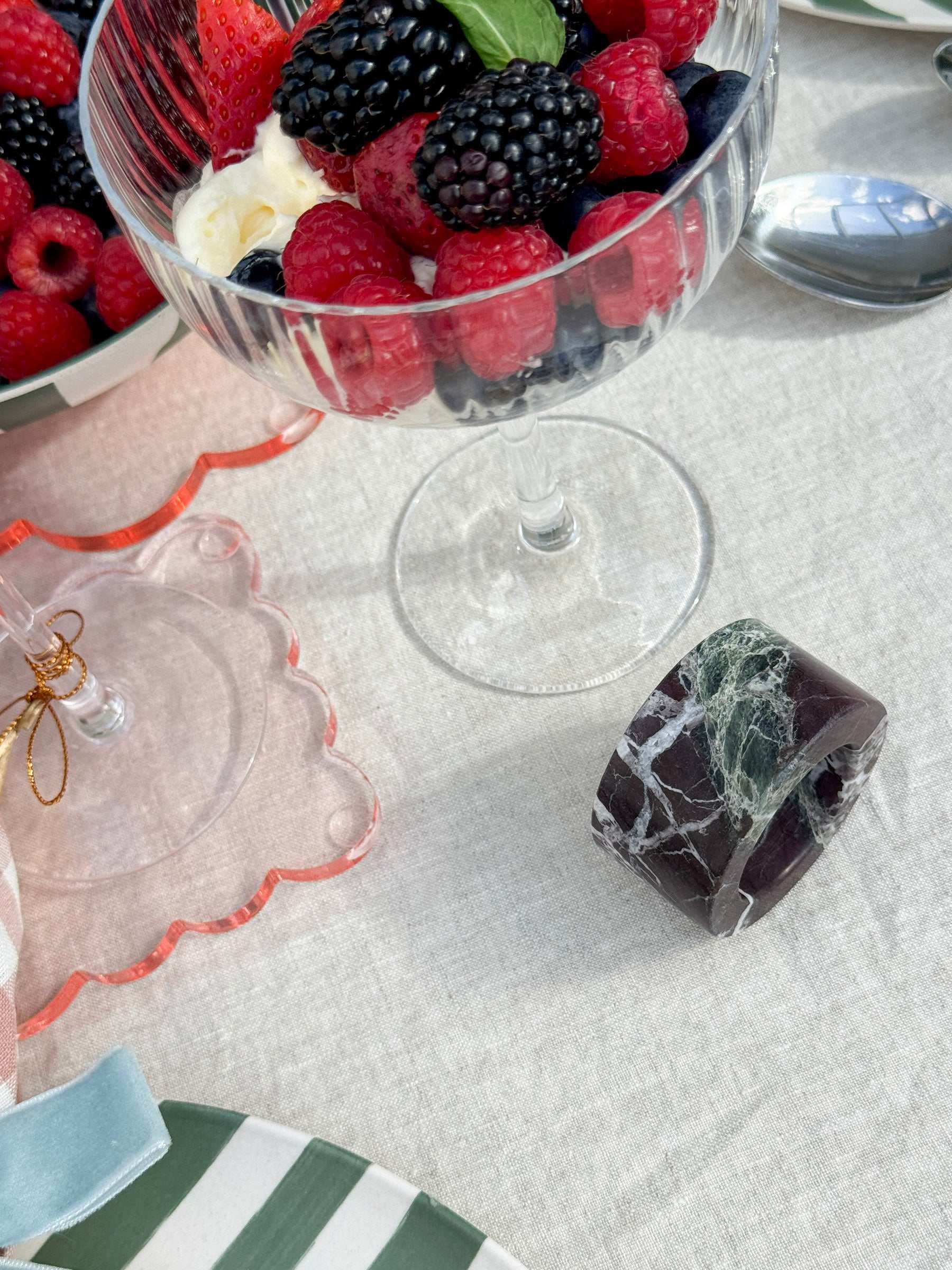 norsu STUDIO Rosso Levanto marble circular napkin ring with white veining on table setting