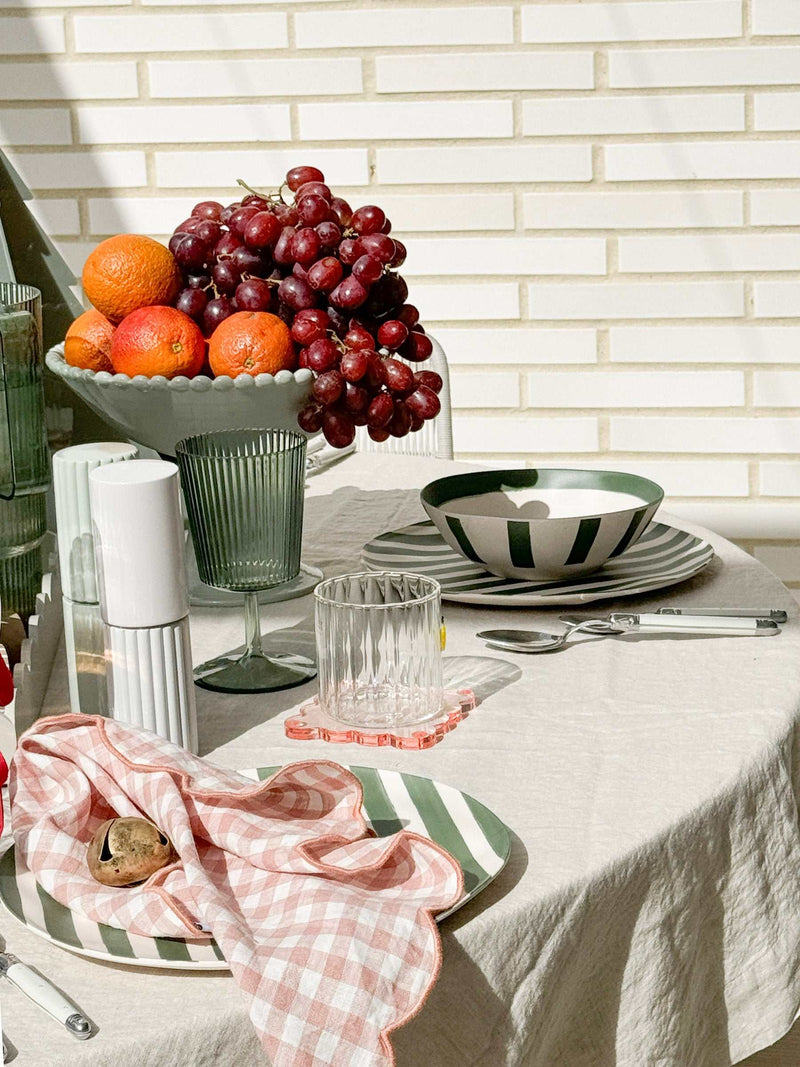 norsu Studio Salt & Pepper Grinders in sage on a modern table setting with fruit and dinnerware