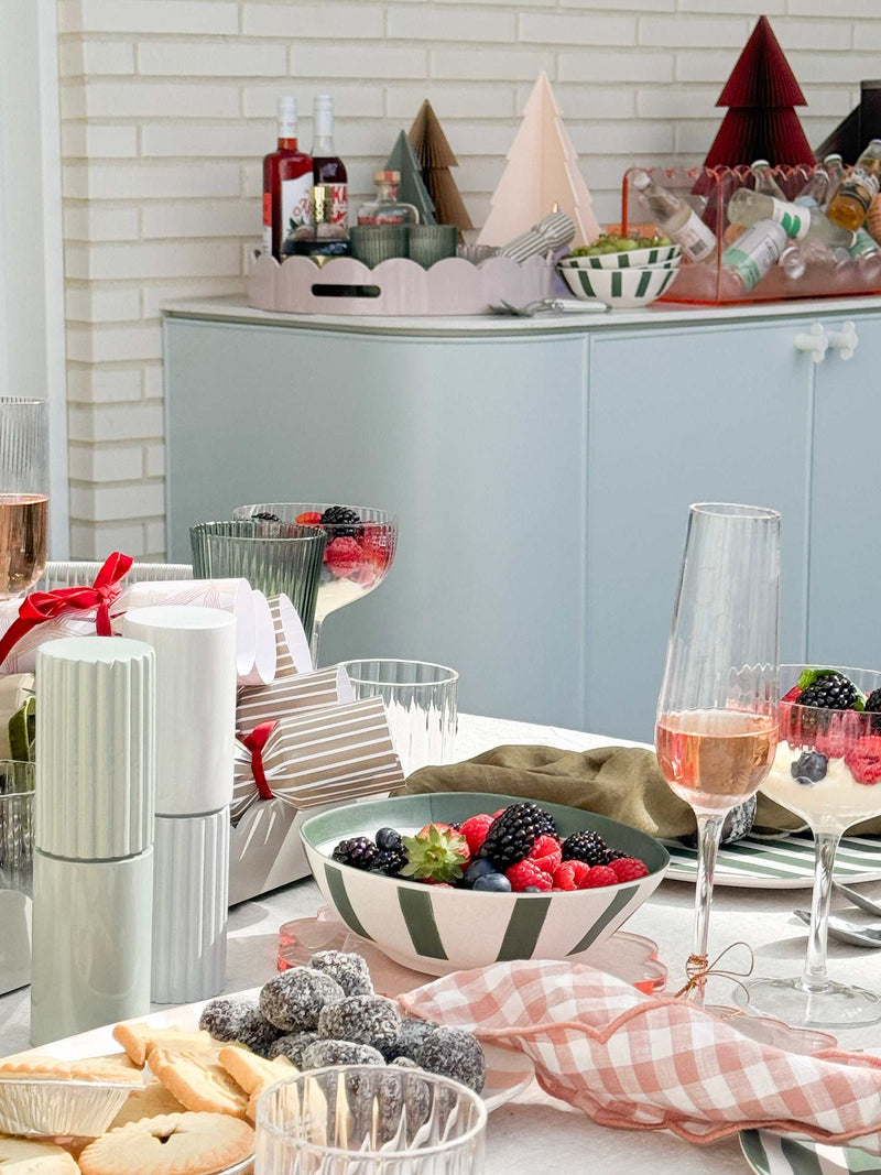 Davis & Waddell 4-piece dark green and mint green bamboo fibre bowl set with striped design on a table with berries and snacks