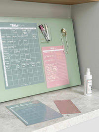 Blush magnet meal planner on fridge with weekly menu and marker pens for organized meal planning