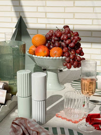 norsu Studio Salt & Pepper Grinders in sage with modern design on dining table setting