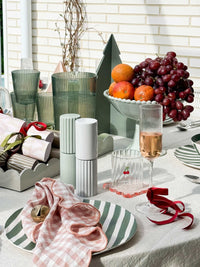 Green Saltara RPET Tumblers 4-piece set by Davis & Waddell on picnic table with fruit bowl and tableware