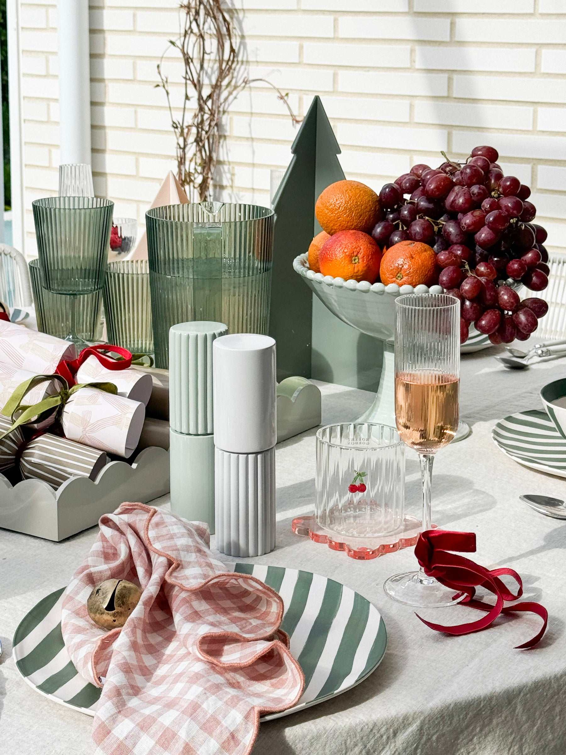 Green Saltara RPET Tumblers 4-piece set by Davis & Waddell on picnic table with fruit bowl and tableware