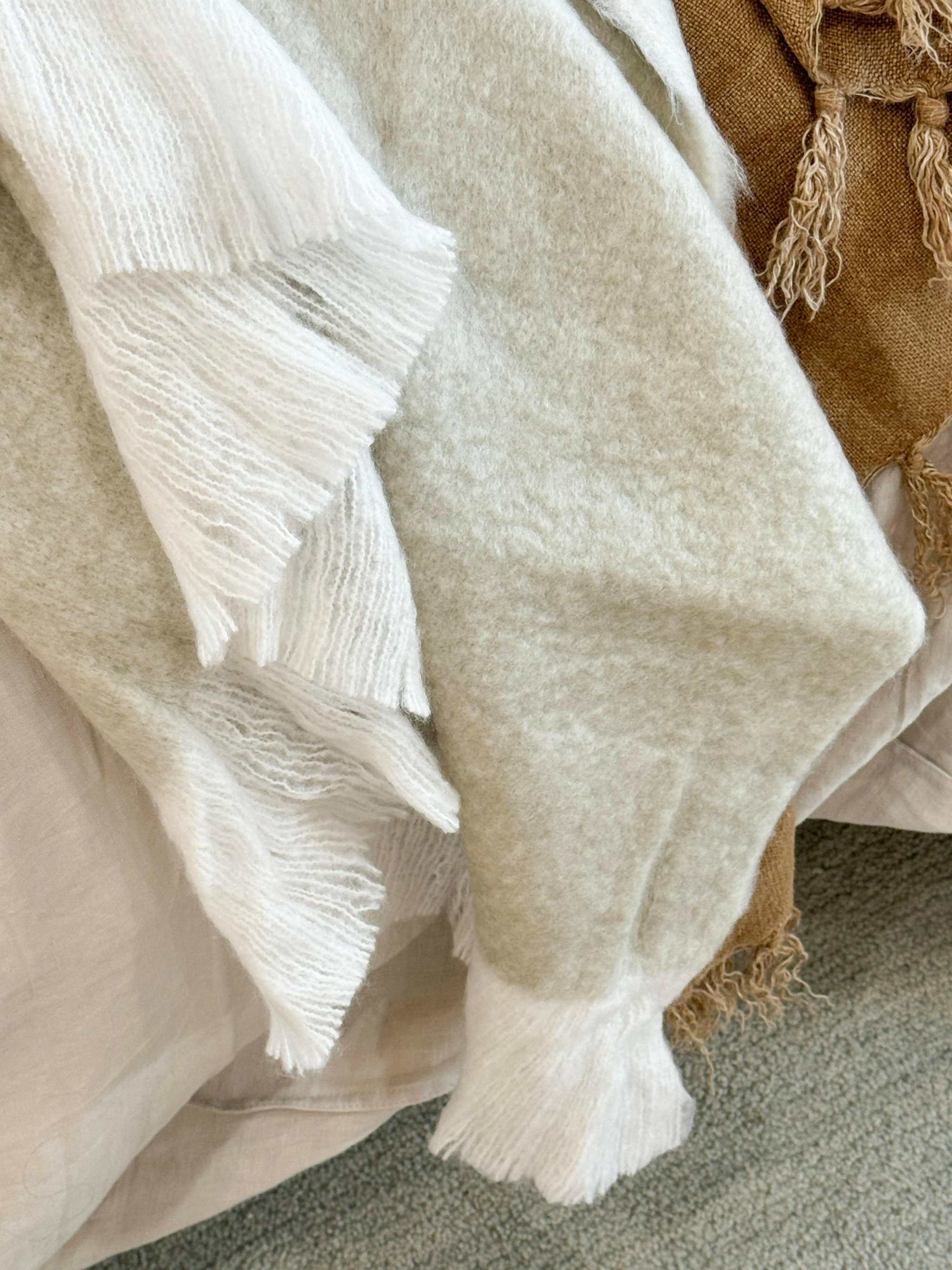 Off-white Baya Sorrento Throw with soft brushed wool texture and feathered fringe detail
