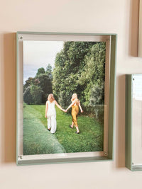 norsu STUDIO sage acrylic box gallery frame displaying photo of two women walking on grass in a park