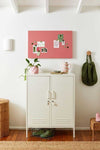 Mustard Made Berry Story Board magnetic wall board with notes above white cabinet in modern room