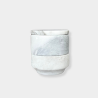 Stackable marble jewellery organiser with unique veining and compact cylindrical design for versatile storage and elegant display.