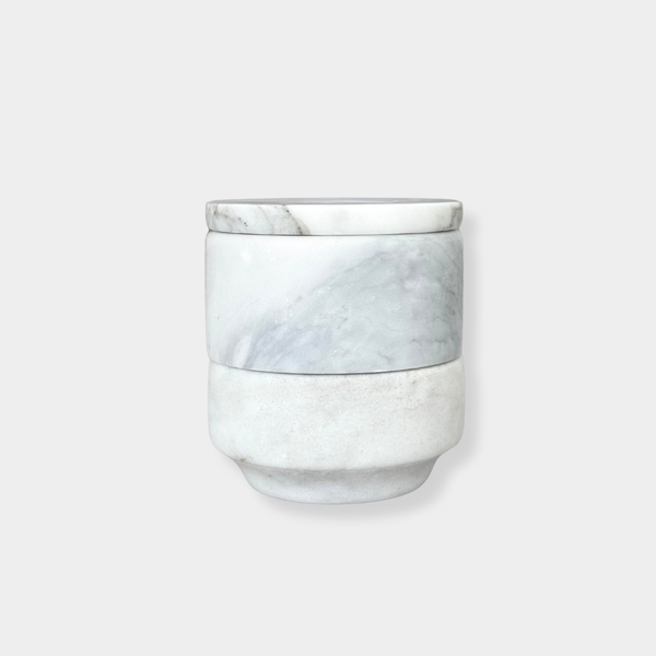 Stackable marble jewellery organiser with unique veining and compact cylindrical design for versatile storage and elegant display.