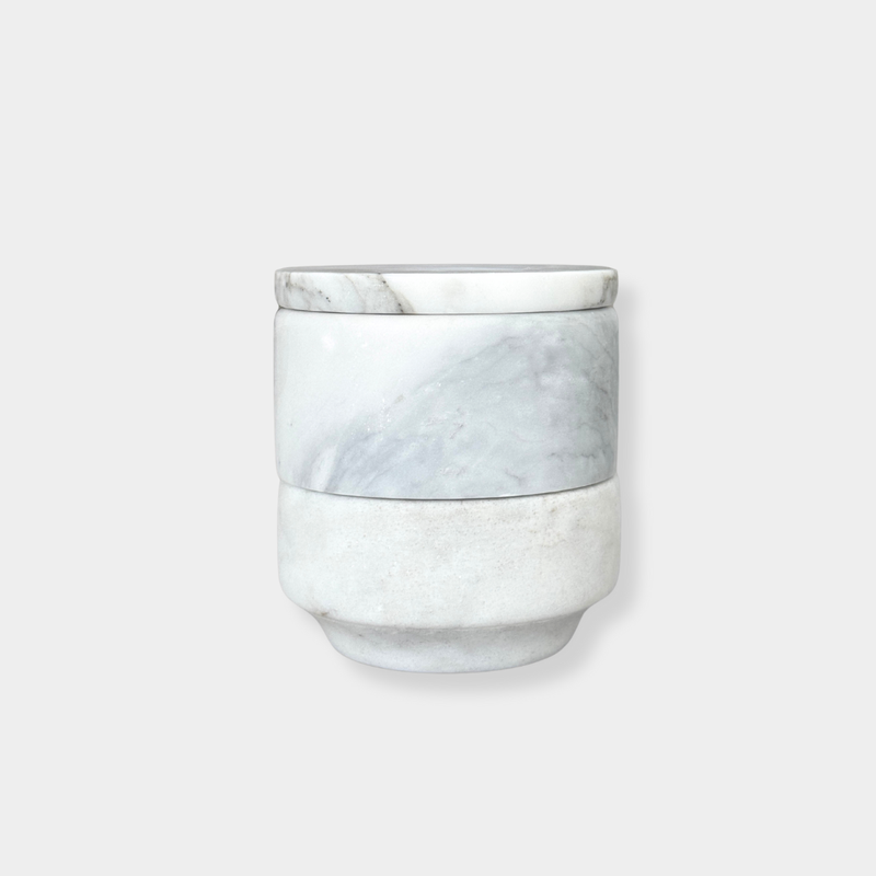 Stackable marble jewellery organiser with unique veining and compact cylindrical design for versatile storage and elegant display.