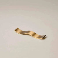 Gentle Habits Brass Wave Incense Holder in smooth brass with wave design for holding incense sticks safely and stylishly