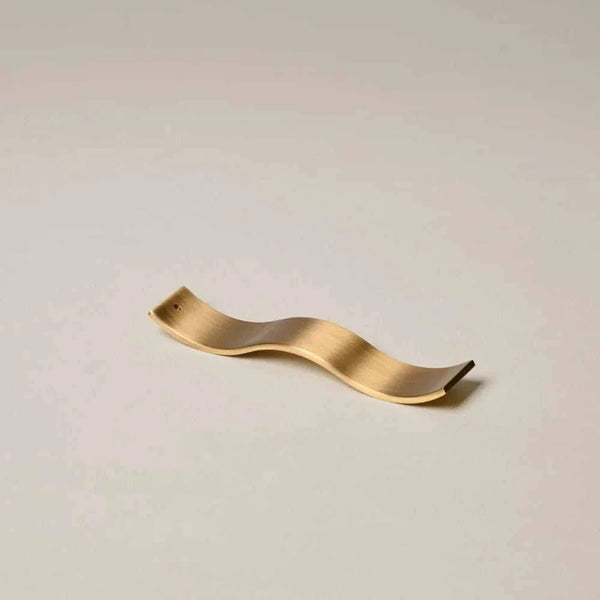 Gentle Habits Brass Wave Incense Holder in smooth brass with wave design for holding incense sticks safely and stylishly