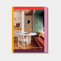 Book cover of Arent & Pyke Interiors Beyond the Primary Palette featuring a colorful modern interior with coral, olive, and nougat tones and a round dining table with chairs.