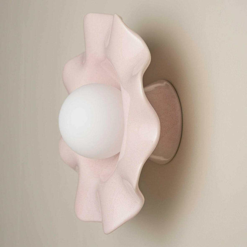 Robert Gordon Pearl Wall sconce in rose quartz ceramic with a round white globe light and ruffled edges