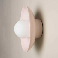 Robert Gordon Dish Wall Sconce in rose quartz ceramic with round dish design and central globe light mounted on wall