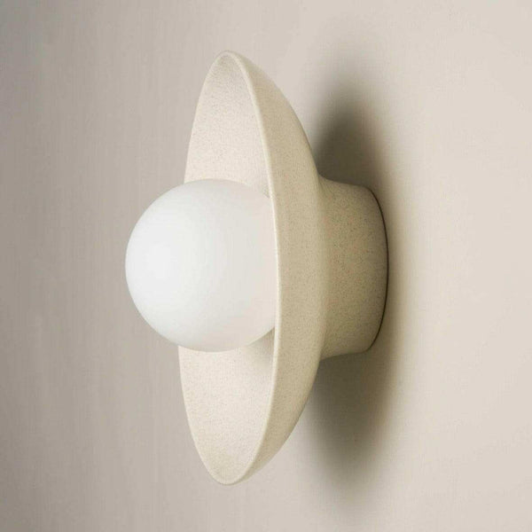 Robert Gordon ceramic dish wall sconce with round white LED globe in poppyseed finish mounted on wall