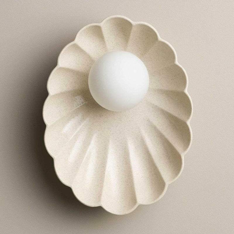 Robert Gordon Oyster Ceramic Sconce Light in poppyseed beige with scalloped bowl shape and halogen globe