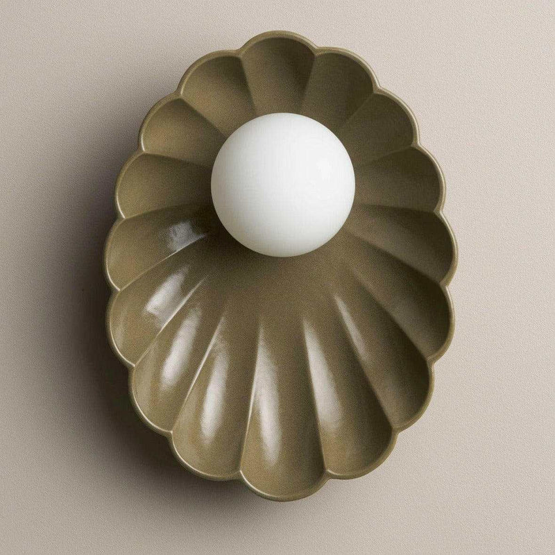 Robert Gordon Olive ceramic oyster-shaped wall sconce with white halogen globe light