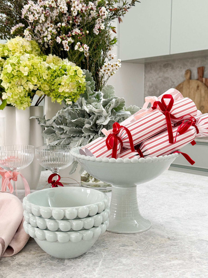 Eden Pedestal Bowl in blue ceramic with beaded rim used as centerpiece on kitchen counter