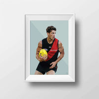 Framed DG Designs Dom Gauci kids art print of Archie Perkins in Essendon Football Club AFL uniform holding yellow football on sage green background