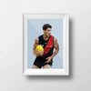 DG Designs Dom Gauci kids art print of Archie Perkins in Essendon Football Club uniform holding AFL football, powder blue background, framed in white