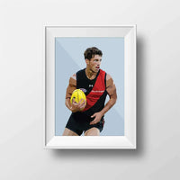 DG Designs Dom Gauci kids art print of Archie Perkins in Essendon Football Club uniform holding AFL football, powder blue background, framed in white