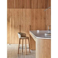 GlobeWest Rufus Indra Bowl in oat marble on kitchen countertop with wooden cabinetry background