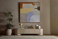 GlobeWest Pluto porcelain entertainment unit with rounded silhouette and circular legs in modern living room.
