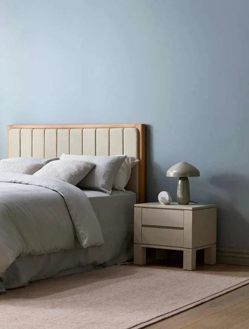 Easton Curve Lamp with Pantone Elm iron base on bedside table in modern bedroom setting