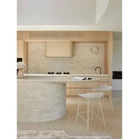 GlobeWest Turner Barstool in birch boucle upholstery with bone powdercoated metal frame in a modern kitchen setting