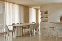 GlobeWest Leon Dining Table - Porcelain, styled in a room setting