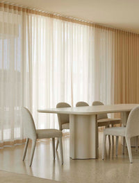 GlobeWest Leon Dining Table - Porcelain, styled in a room setting